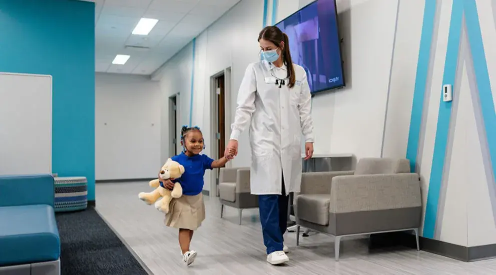 Dentist holding hands with child