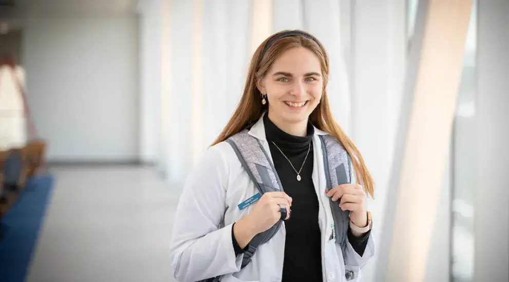 Christy Heimbrecht smiling with backpack