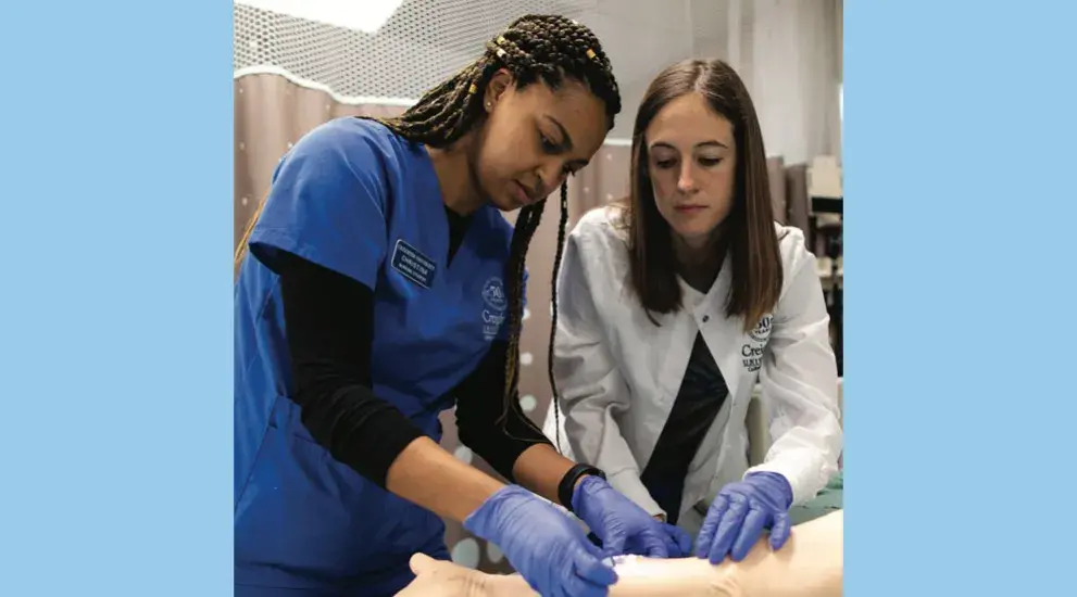 Nurses learning in lab environment.