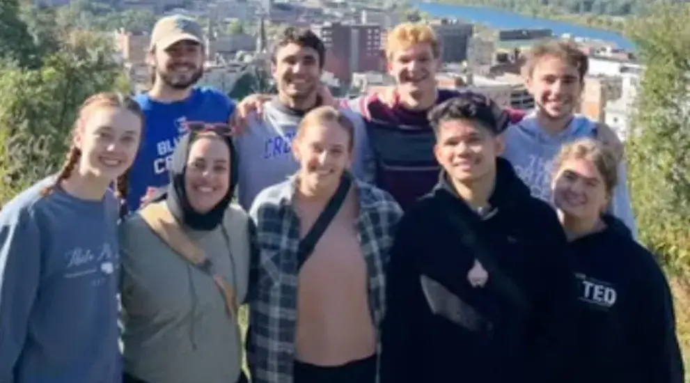 Students smiling in group picture outside in West Virginia.