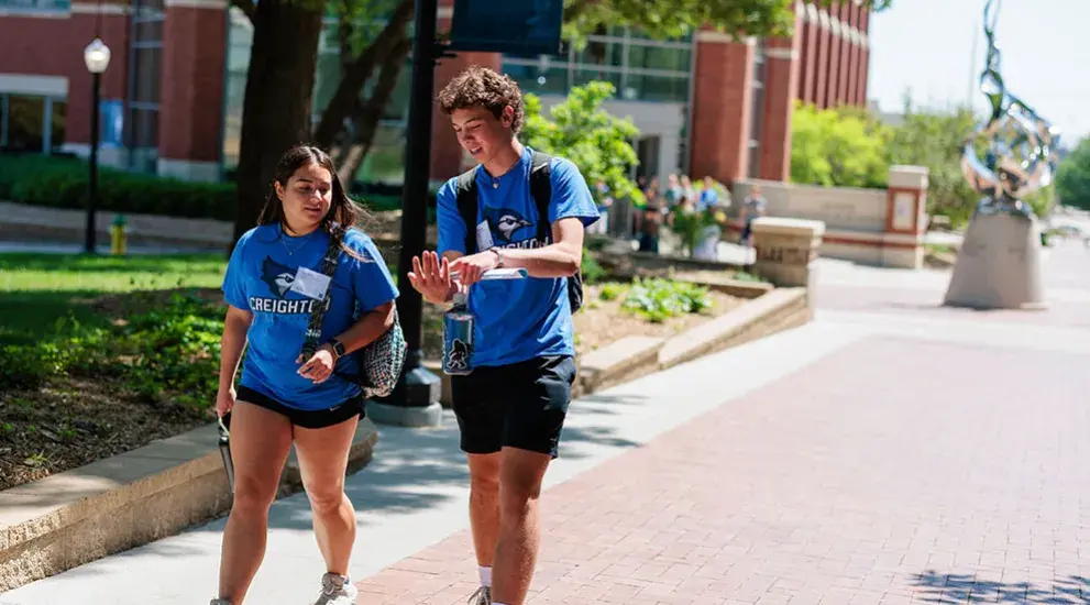 Student tour guides walking outside on the mall