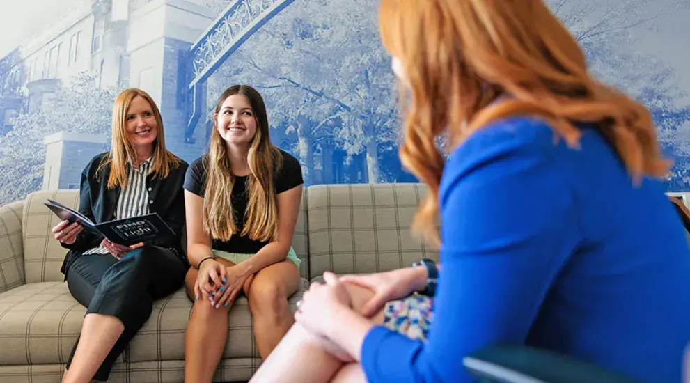 Mother and daughter meeting with aid counselor