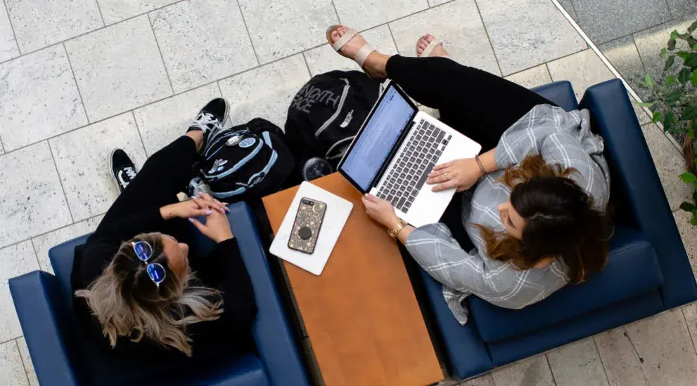 Gradute students sitting in chairs studying