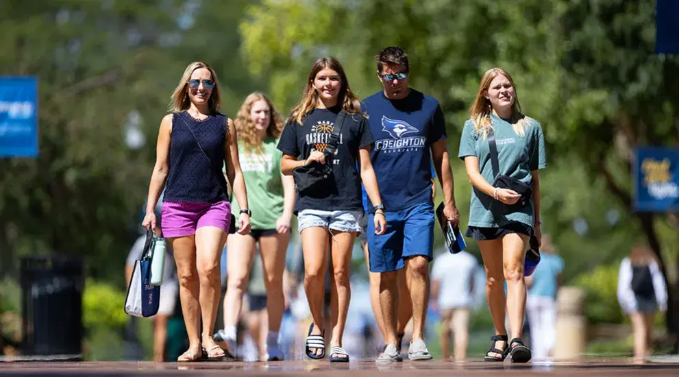 Family walking on campus during tour