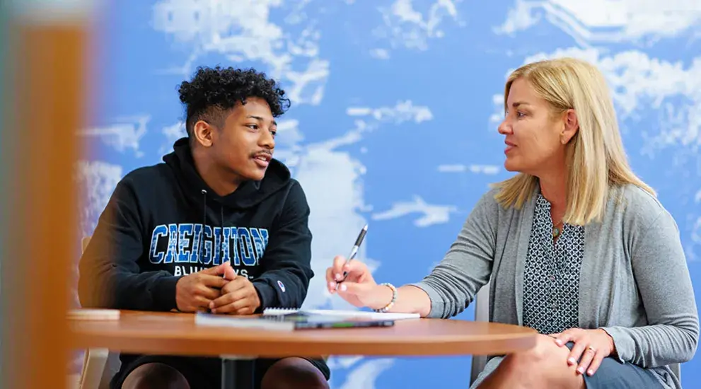 Student talking with aid counselor