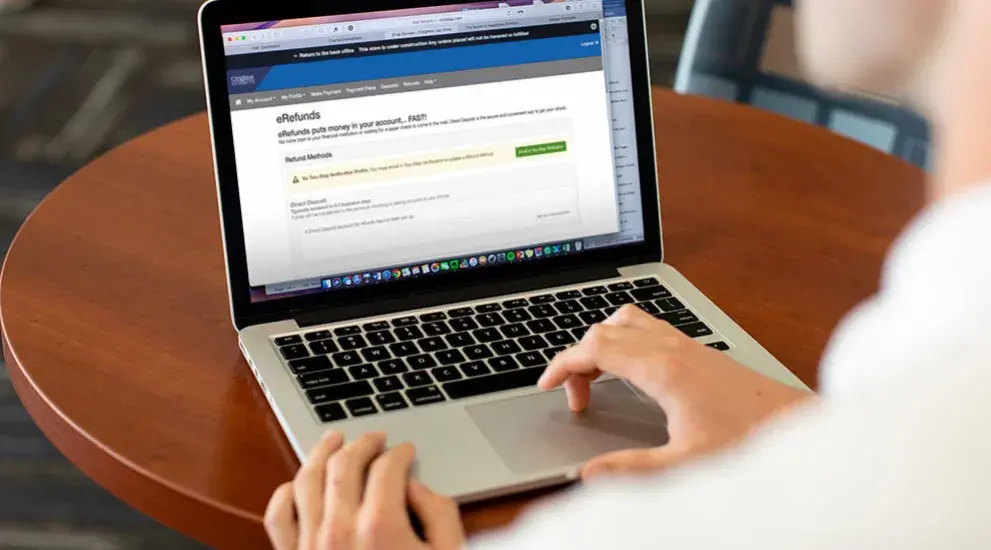 student on laptop sitting at a table
