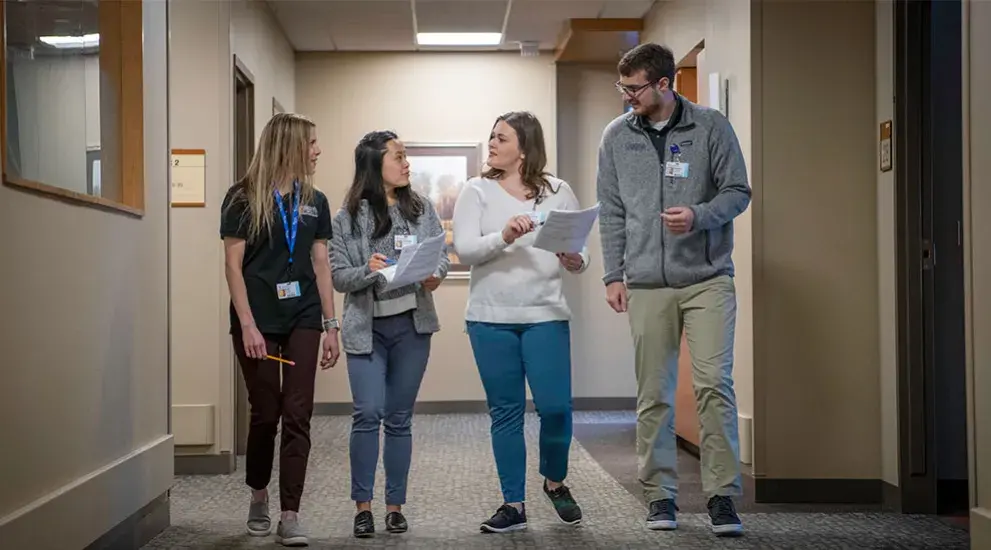 PT residents talking with faculty member