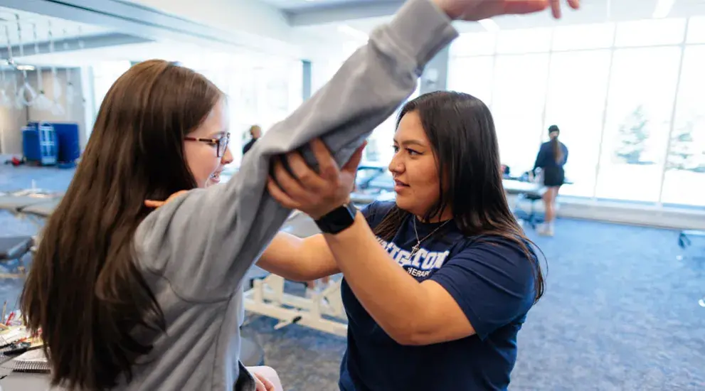 Physical therapy resident working with patient