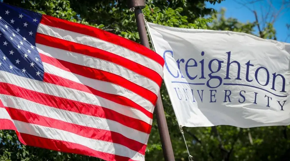 American flag next to Creighton University flag