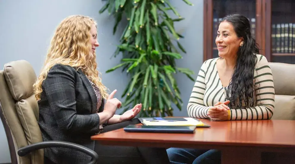 Two women consulting at law clinic.