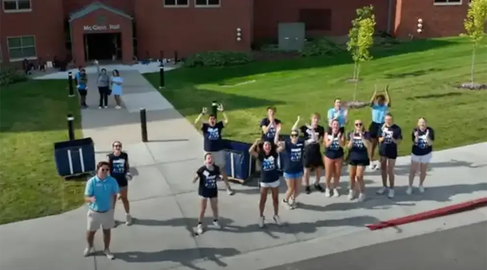 New students jumping up and down in excitement on move-in day.