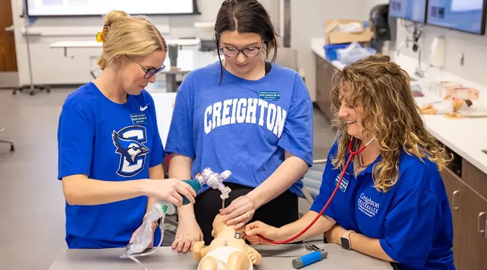 Nursing students with baby