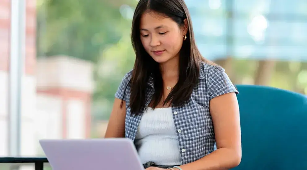 student on laptop in quiet study area