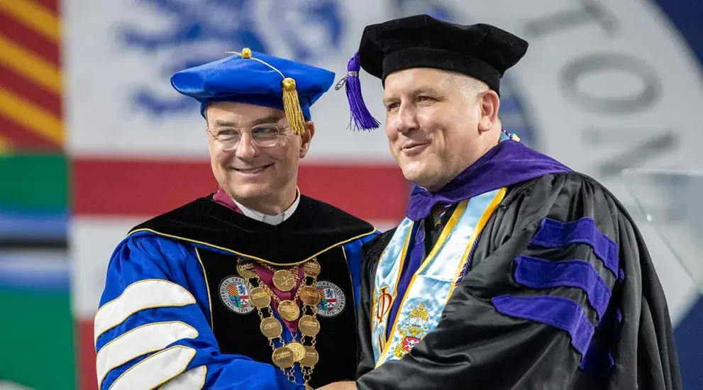 Creighton law school graduate Matthew Badell with Creighton president the Reverand Daniel S. Hendrickson of the society of jesus