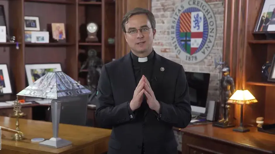 Father Hendrickson talking to camera