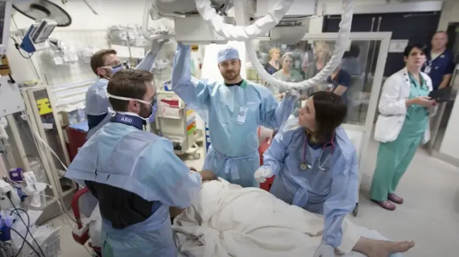 Medical professionals working together in emergency room environment.