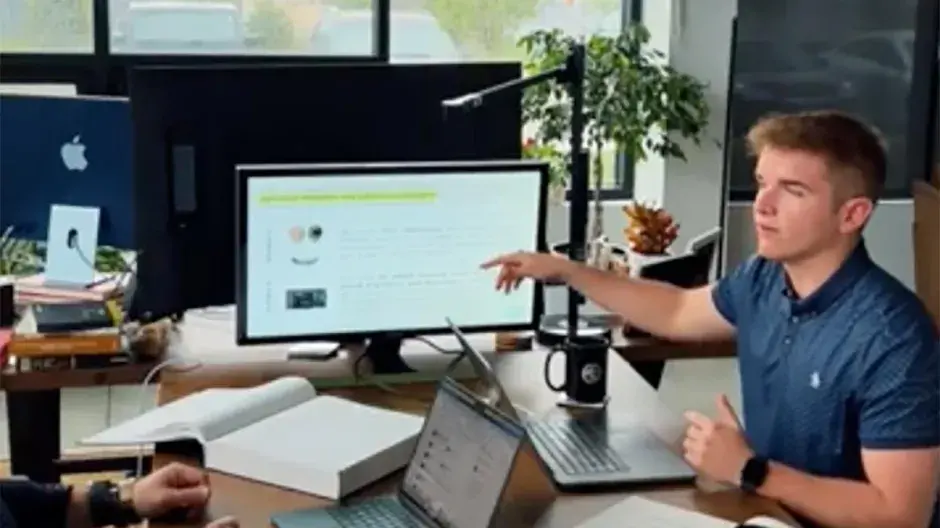 Lucas Lunzmann at work in conference room at internship.