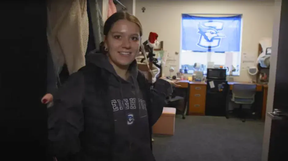 Student giving tour of Graves Hall room.